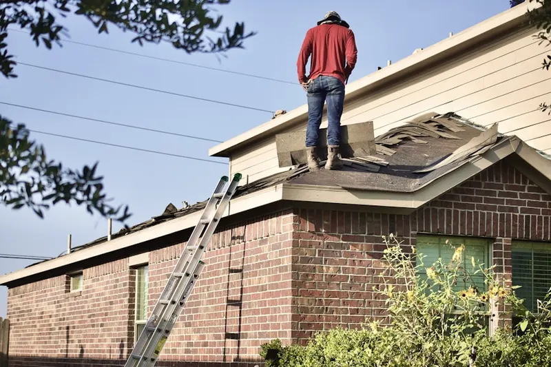 Professional roofer working on a residential roof in Young